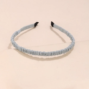 Close-up of light blue ruched fabric headband with premium pleated texture and comfort tips