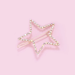 Star-shaped gold hair clip with colorful rhinestones on a sweet pink background
