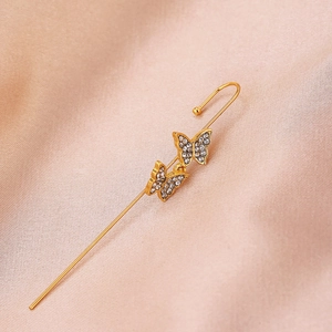 Detail showing double butterfly ear crawler with clear crystals and golden finish