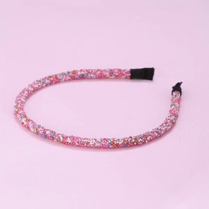 Detailed macro shot of pink headband featuring vibrant multi-colored micro-bead embellishments