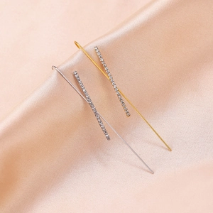 Macro detail of gold and silver crawler earrings featuring sparkling zirconia inlay