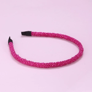 Detailed view of the rose pink beaded headband with secure black fabric protective tips