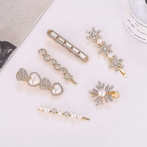 Elegant 6-piece gold hair clip set with white pearls, rhinestones and snowflake motifs