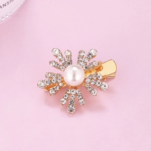 Elegant gold snowflake hair clip with central pearl and sparkling rhinestones for girls