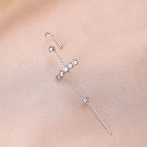 Detail of silver ear crawler featuring seven round cubic zirconia stones on silk