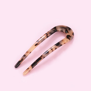 Close-up of leopard pattern U-shaped hair pin in retro tortoiseshell acetate texture
