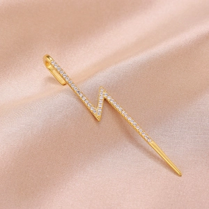 Detailed view of gold lightning bolt ear cuff with sparkling pavé cubic zirconia