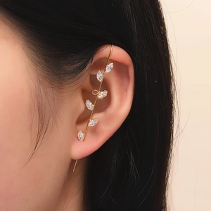Macro view of gold leaf-shaped ear crawler with sparkling marquise-cut zircon stones