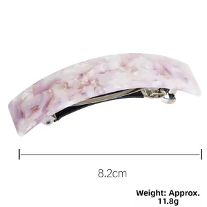 Detail view of acetate spring hair clip in purple and pearl white marble pattern