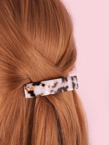 Rectangle leopard print acetate hair claw clip shown on reddish-brown hair