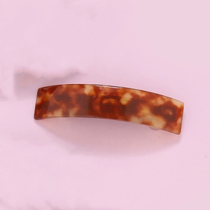 Detail view of rectangular tortoiseshell acetate hair claw clip with leopard pattern