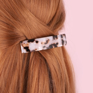 Elegant leopard print acetate hair claw clip for women on light brown hair stylishly styled