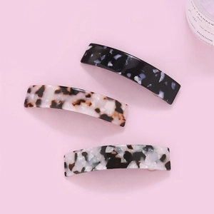 Three-piece set of acetate hair claws with elegant leopard and marble textures on pink background