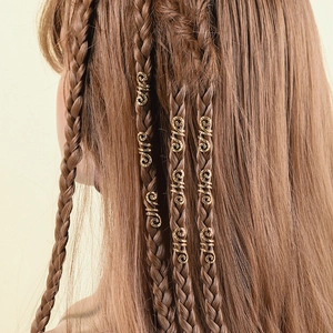 Detail of spiral metal hair clips in golden finish on long braided hair style