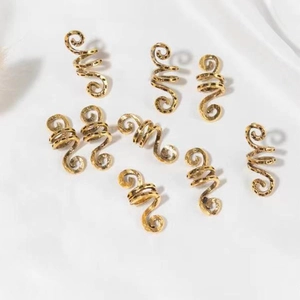 Detailed view of nine gold spiral dreadlock hair rings with hammered metal texture