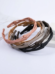 Detail of four foldable plastic headbands in matte finish with non-slip inner teeth design