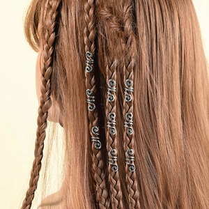 Detailed view of silver spiral hair coils on braided hair for ethnic dreadlock styles