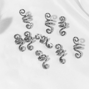 Silver spiral hair rings for dreadlocks with vintage patterns on white silk background