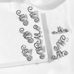 Macro detail of silver spiral metal hair clips with vintage textured finish for braids