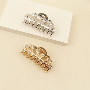 Elegant hollow fan-shaped metal hair claws in gold and silver with textured finish