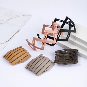 Matte stretch bird nest hair bands in five colors shown open and folded on marble