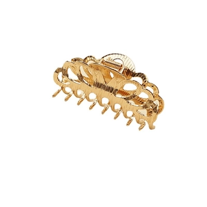 Elegant gold metal hair claw clip with a wavy hollow design and brushed finish texture