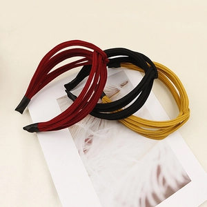 Detailed set of three ribbed fabric headbands in burgundy black and mustard yellow colors