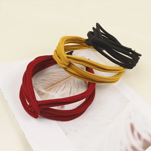 Knotted fabric headbands in red yellow and black with minimalist knitted stripe texture