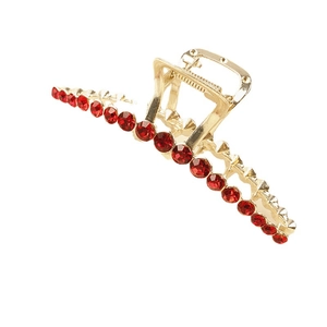 Eleganter Haargreifer aus goldener Legierung mit roten Strasssteinen und Federclip