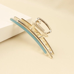 Detail of light blue enamel inlay on a polished gold alloy shark hair claw clip