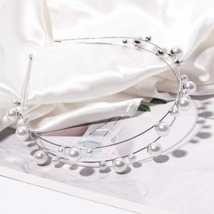 Elegant double-layered silver pearl headband with assorted white pearls on satin background