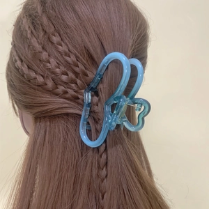Blue translucent hollow heart-shaped hair claw clip made of resin with metal spring