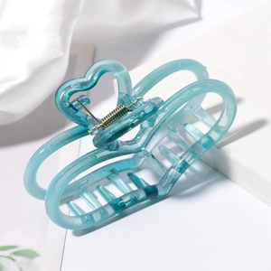 Detail of a large translucent blue hair claw clip with heart-shaped hollow design