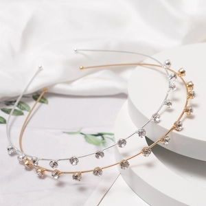 Elegant gold and silver metal headbands with sparkling rhinestones on white display