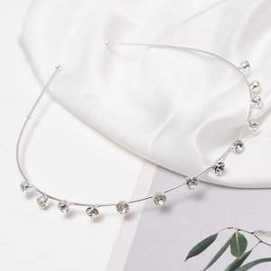 Close-up of elegant silver headband with 11 sparkling rhinestones in a claw setting