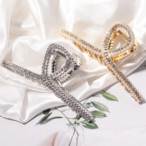 Elegant gold and silver hair claw clips with sparkling rhinestones and pearls on silk