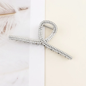 Detail view of large silver metal hair claw clip with elegant double-row pearl inlay
