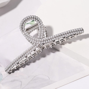 Detail of silver metal hair claw clip with pavé white pearls and ring-shaped handle