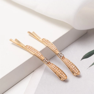 Elegantes Haarspangen-Set in Gold mit weißen Perlen und glitzerndem Strass-Schleifendesign