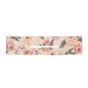 Detail of floral Deft Bun hair tool with pink roses and yellow flowers on white background