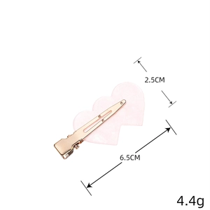 Pink heart-shaped acetate hair clip with gold metal spring clamp and size markings
