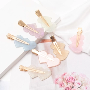 Elegant wavy heart acetate hair clips in seven macaron colors with golden metal base