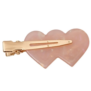 Pink pearlescent heart hair clip with gold metal alligator clip on white background