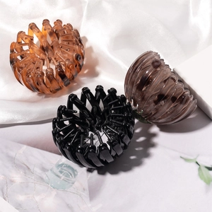 Three-piece expandable bird nest hair clips in amber, black, and coffee for bun styling