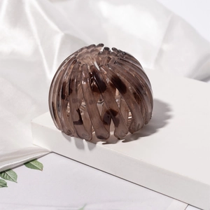 Detail of tortoise shell bird nest hair clip with flexible expanding resin design