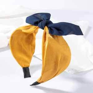 Serre-tête large jaune avec nœud bleu marine à pois de style élégant