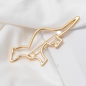 Minimalistische goldene Haarklammer in Dinosaurierform mit polierter Metalloberfläche