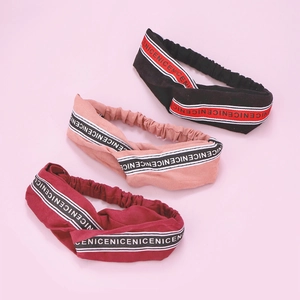Three NICE lettered elastic twist headbands in black, pink, and burgundy colors