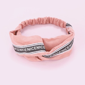 Detailed view of pink twisted headband with NICE letters and elastic back band
