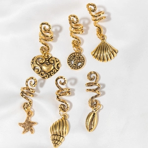 Detailed view of six vintage gold spiral hair clips with heart, shell and starfish charms